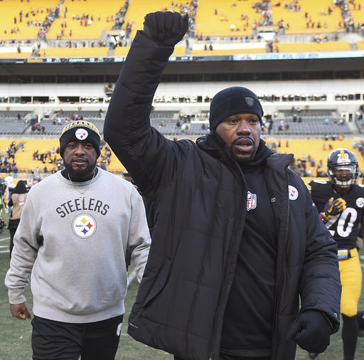In this Jan. 8, 2017 photo, Pittsburgh Steelers linebackers coach Joey Porter, right, and head coach Mike Tomlin leave the field after defeating the Miami Dolphins. Porter has been arrested at a Pittsburgh bar following the team's wild-card win over the Miami Dolphins on Sunday, Jan. 8, 2017. (Christopher Horner/Tribune Review via AP)