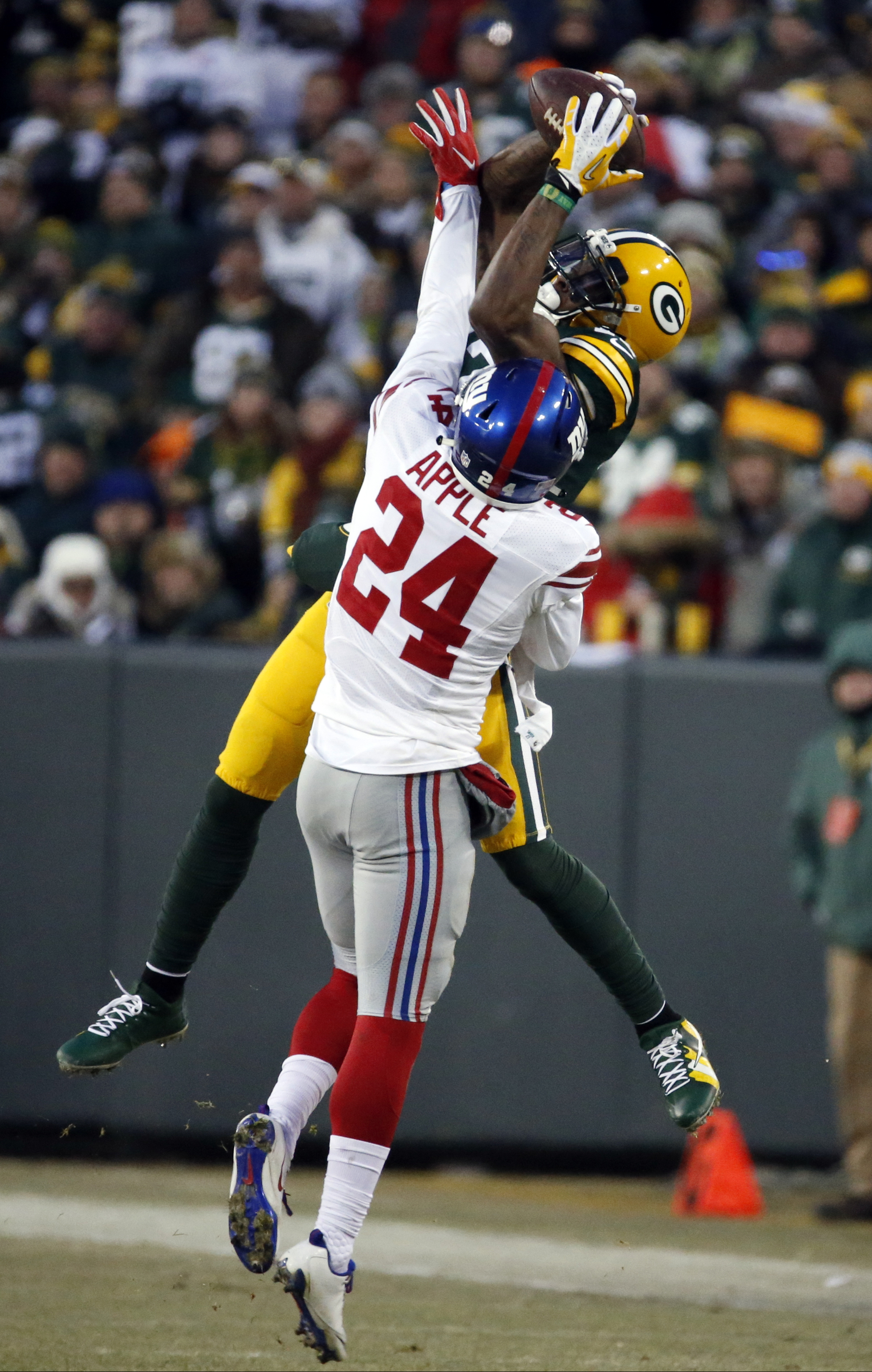 New York Giants cornerback Eli Apple (24) breaks up a pass intended for Green Bay Packers wide receiver Davante Adams (17) during the first half of an NFC wild-card NFL football game, Sunday, Jan. 8, 2017, in Green Bay, Wis. (AP Photo/Mike Roemer)